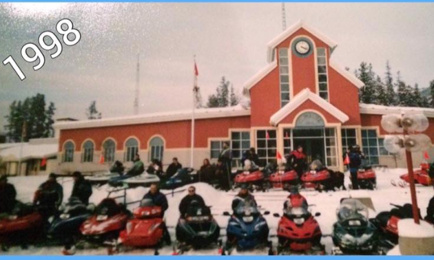 An old photo of snowmobiles parked in front of Tumbler Ridge City Hall.