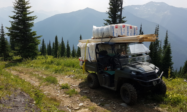 An ATV is loaded up with a heaping amount of supplies.
