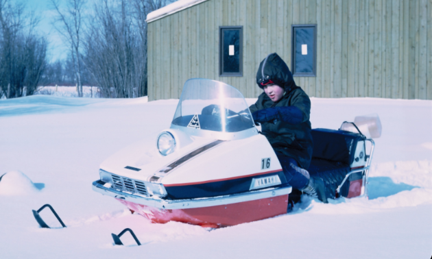 Bill Hammond’s son David at 10 years old rides a snowmobile