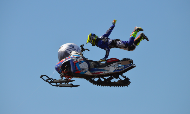 Dan Shaffer holds onto his snowmobile with one hand