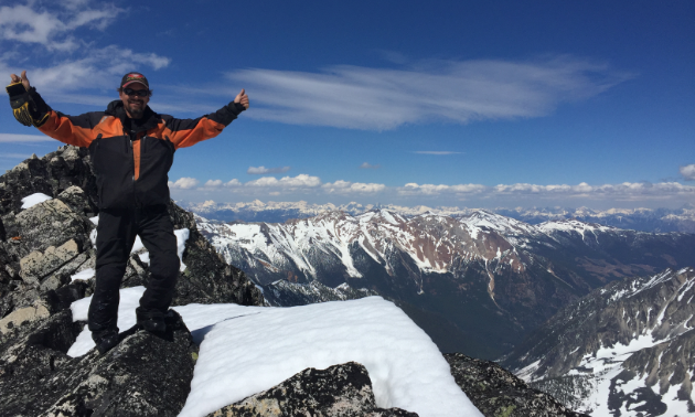 Dean Ingram stands proudly on top of a mountain near Radium.