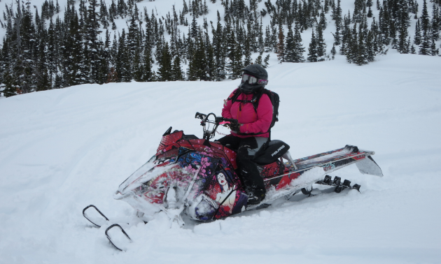 Kelsey Poelt rides a pink snowmobile on the first day of spring.