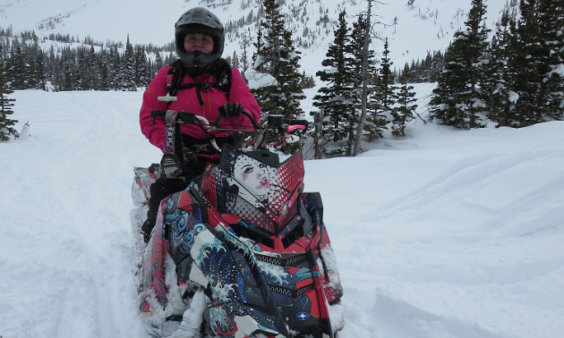 Kelsey Poelt poses on her pink snowmobile on the first day of spring.