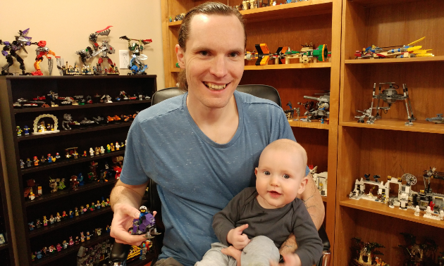 Kyle and Augustus Born smile while playing in the Lego room