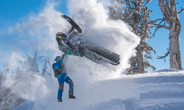 Logan Thibodeau flies his snowmobile above his head