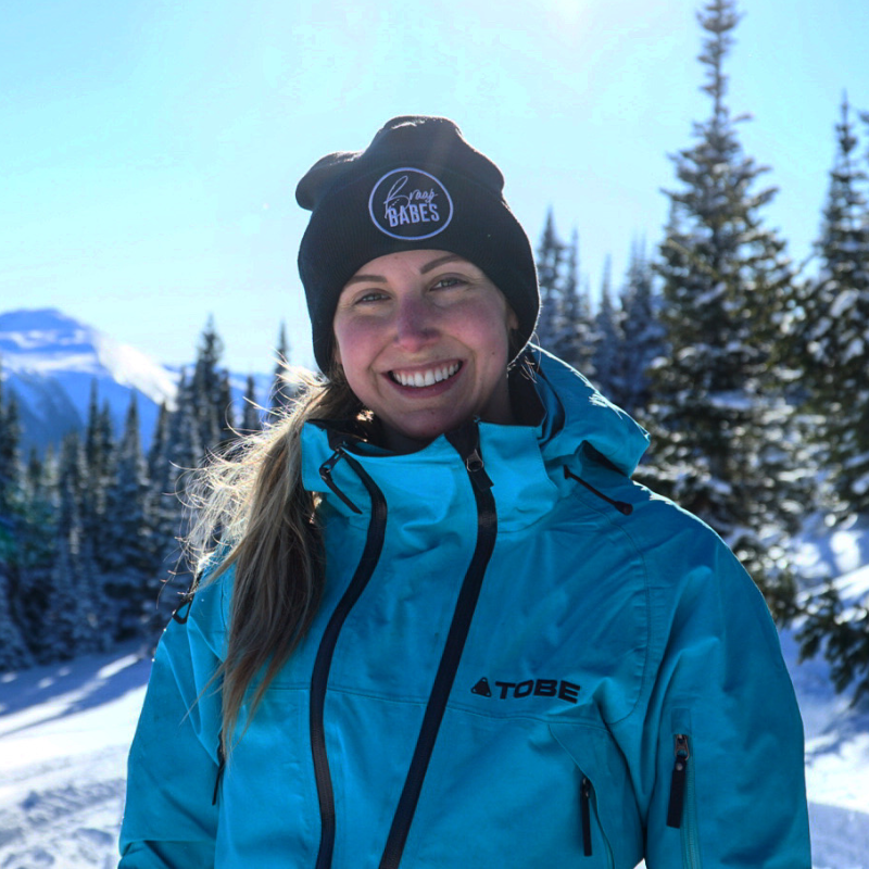 Genevieve Byl wears a blue jacket and a black toque out in the snowy mountains. 