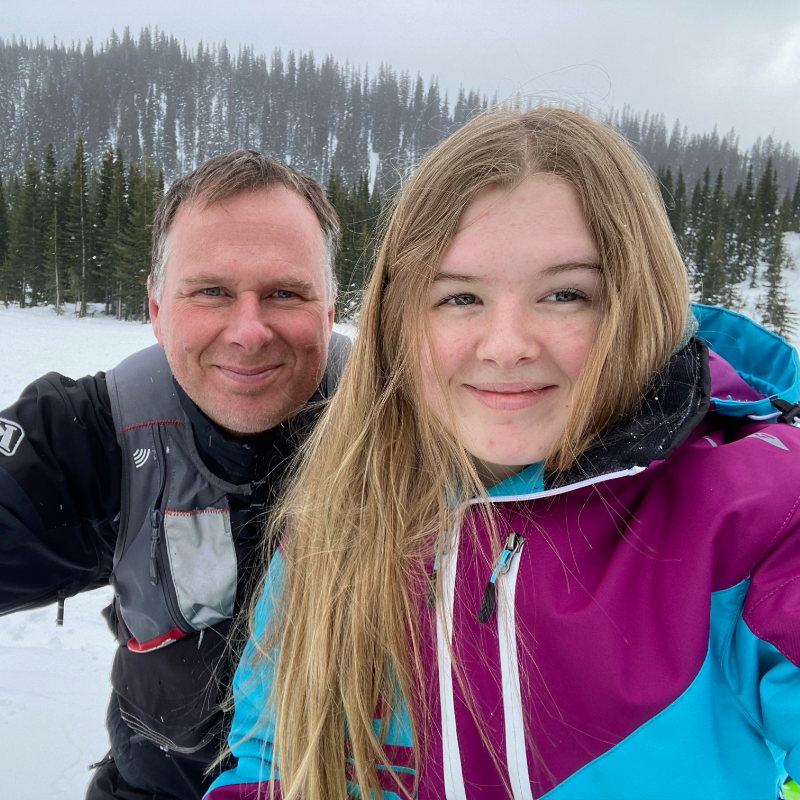 Shawn Schwengler and Madison Schwengler smile for a photo on a snowy mountain. 