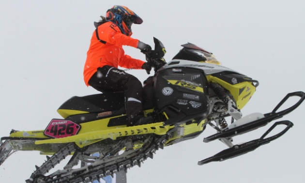 Ashley Chaffin in mid-air on her snowmobile.