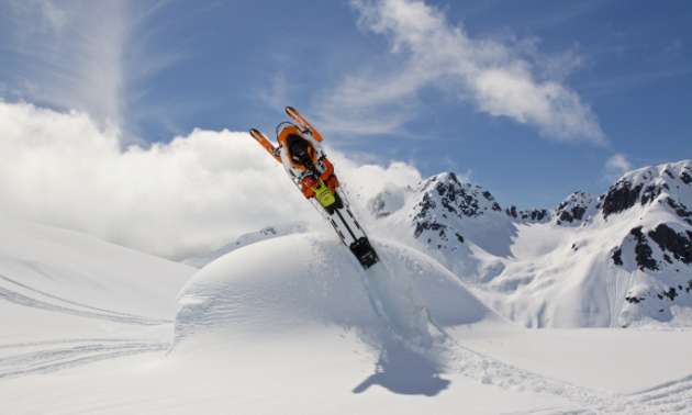 Ashley Chaffin does a backflip on her snowmobile.