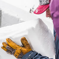 An Avalanche Canada public avalanche forecaster examines the snowpack