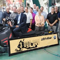 Photo of the three millionth ski-doo snowmobile and the people who made it happen