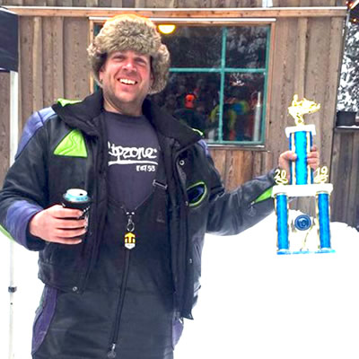 Kris Peltzer, first place Poker Hand winner, shown holding up his trophy. 