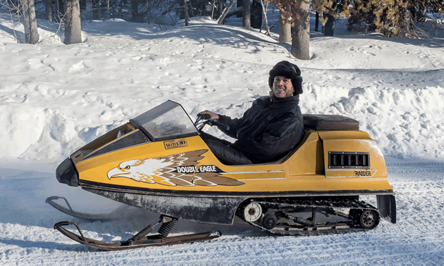 Man riding on a Double Eagle Raider snowmobile. 