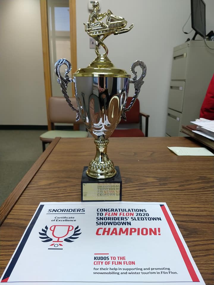 The SledTown ShowDown trophy on a desk in an office. 