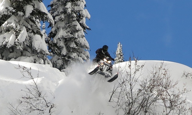 A sledder coming over the bank above the camera view. 