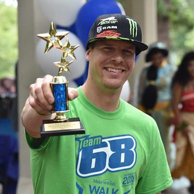 Tucker Hibbert shows off a first place trophy for the team's efforts at the Make-A-Wish event in Minnesota. 