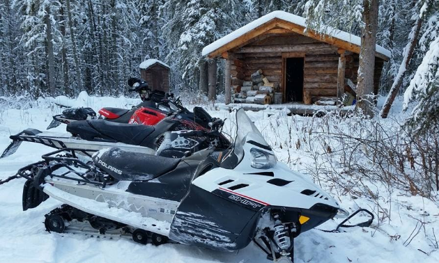 Riders are taking a break at a ski cabin west of Hutch Lake.