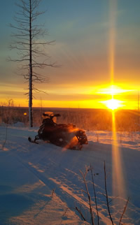 A snowmobile and a beautiful sunset in Hudson Bay, Saskatchewan.