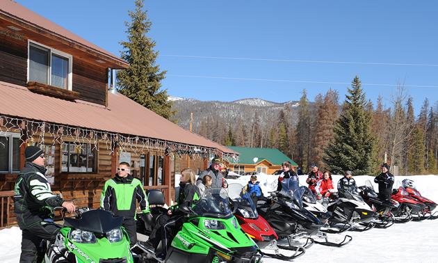 ISMA snowmobilers outside lodge