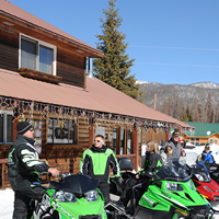 ISMA snowmobilers outside lodge