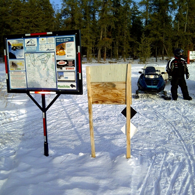 A poster board with trail map made by the Manitoba's Snoman club. Their new map is interactive. They have over 150 of these guide posters throughout their trail system.