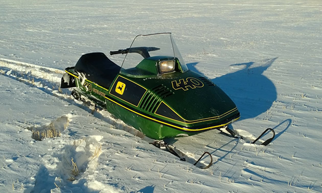 A snowmobile out on a snowy field. 