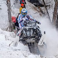 Keith Curtis riding snowmobile