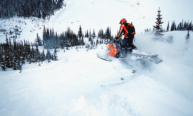 Kristien Larouche jumps his Polaris sled on a mountain slope.