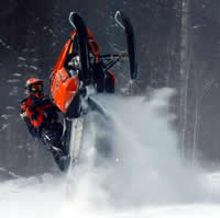 Kristien Larouche jumps his Polaris sled on a mountain slope.