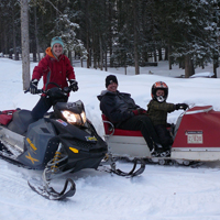 Family on vintage snowmobile