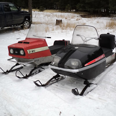 A vintage Mercury sled and a Ski-Whiz sled. 