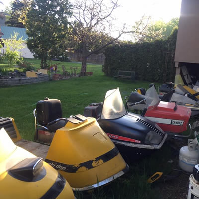 A backyard full of snowmobiles. 