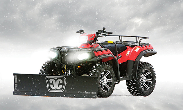 A Polaris Sportsman with a Cycle Country straight steel blade accessory.