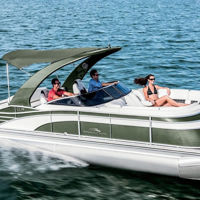 A pontoon boat, speeding in the water. 