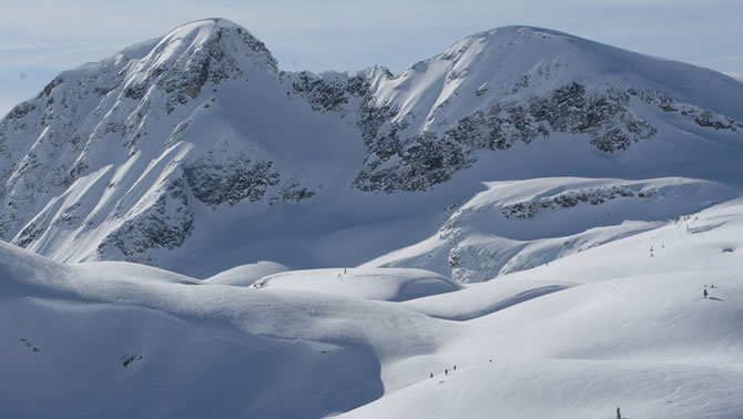 A panoramic view of a snow-covered mountain in the Blue River Powder Packers snowmobile club area