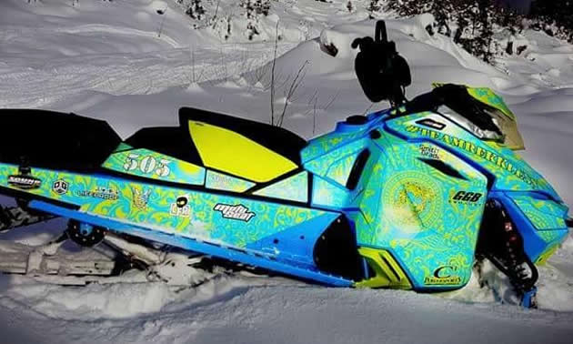 A green, blue and yellow sled wrap on a Ski-Doo. 