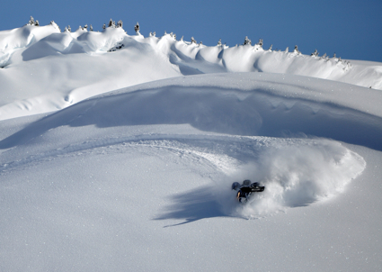 Person sledding in fresh powder