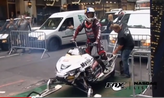 A 15 foot stunt jump on snowmobile to launch NASDAQ market site 