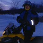 Man and woman beside snowmobile