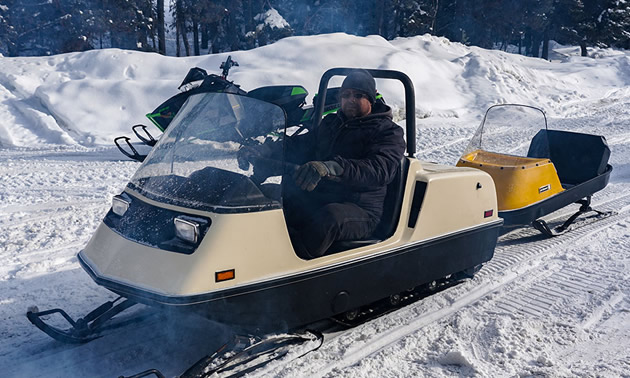 A Ski-Doo Elite, towing a cutter behind it. 