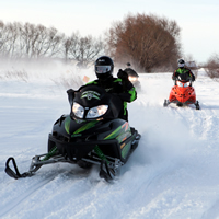 Snowmobilers come down the trail at Manitoba's annual Sled for Eternity event.