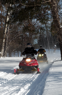 Snowmobilers come down the trail at Manitoba's annual Sled for Eternity event.