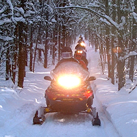 Snowmobiles travel down the Iron Horse Trail near St. Paul, Alberta