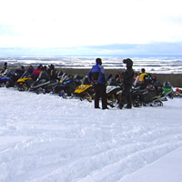 A line-up of sledders are parked on a ridge near Swan River, Manitoba. 