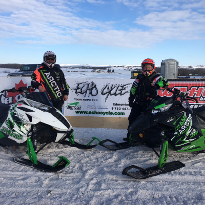 Cory Carter and his wife, Jennifer O'Connor, posing with their snowmobiles after the Lloydminster drag races where they took home nothing but first-place finishes.