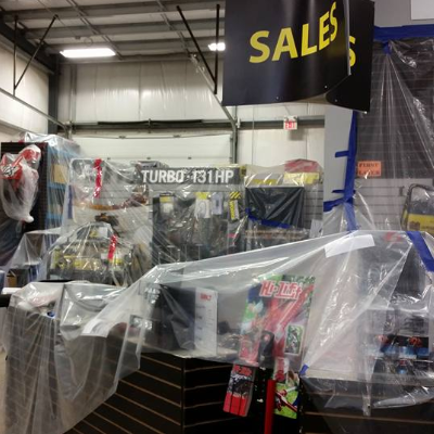 The inside of a store with plastic covering much of the merchandise