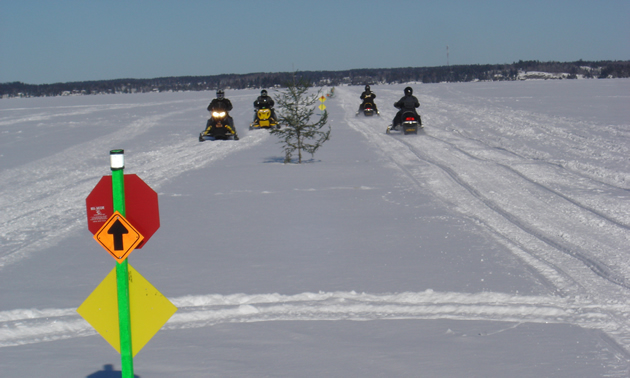 Snowmobilers on a lake in Whiteshell Provincial Park, Manitoba