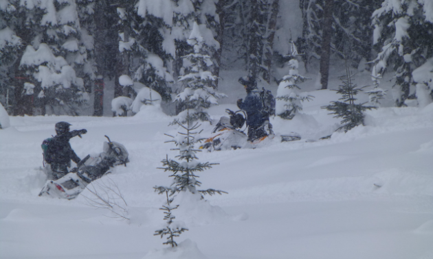 Some snowmobilers got stuck during the poker run last year. Mike and Harvey Jones usually run the sweepers at the back of the pack and pull everyone out.