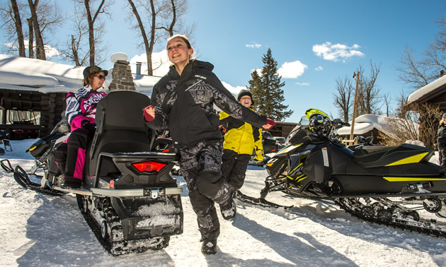 Family getting ready to go snowmobiling. 