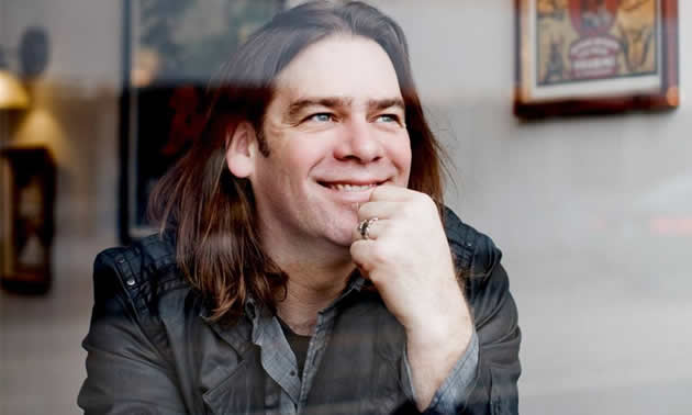 Alan Doyle's profile picture with guitar. 
